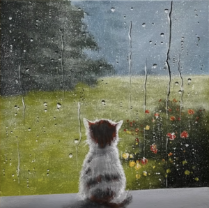 Kitten in a window overlooking a rainy day